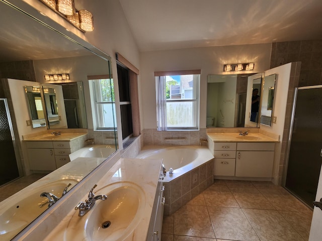 full bathroom featuring tile patterned floors, vaulted ceiling, toilet, vanity, and independent shower and bath