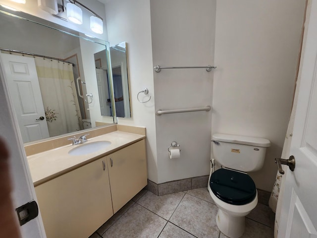 bathroom featuring toilet, vanity, and tile patterned floors