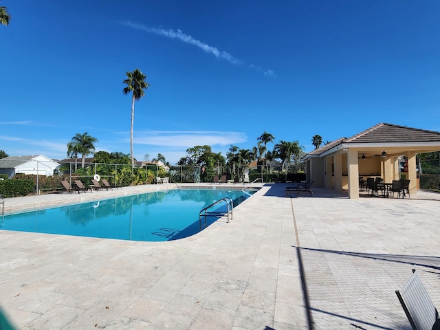 view of pool with ceiling fan and a patio area