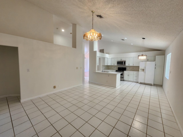 kitchen featuring backsplash, sink, hanging light fixtures, white cabinetry, and stainless steel appliances