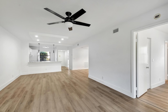 unfurnished living room with ceiling fan and light wood-type flooring