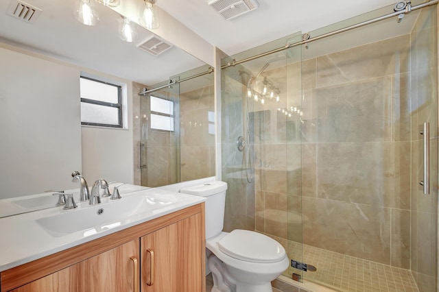 bathroom featuring vanity, an enclosed shower, and toilet