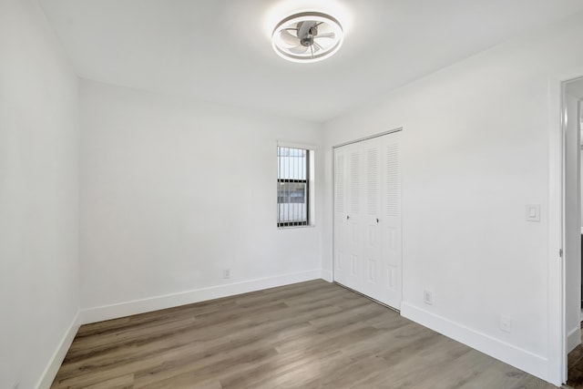 unfurnished bedroom featuring hardwood / wood-style flooring and a closet