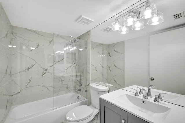 full bathroom featuring vanity, tiled shower / bath combo, and toilet