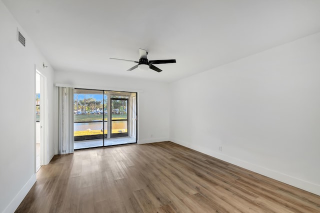 spare room featuring hardwood / wood-style flooring and ceiling fan