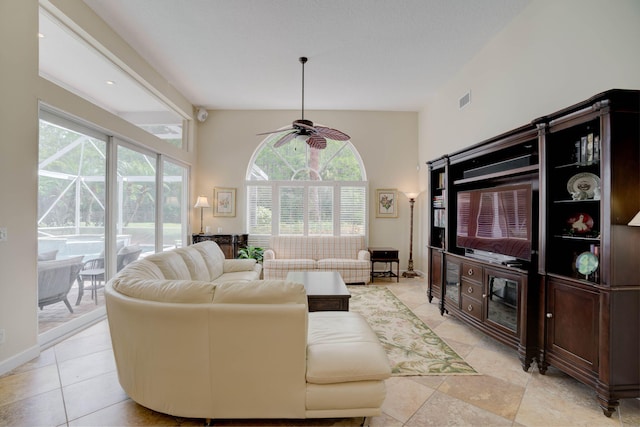 tiled living room featuring ceiling fan