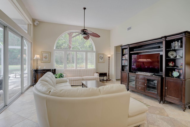 tiled living room featuring high vaulted ceiling and ceiling fan