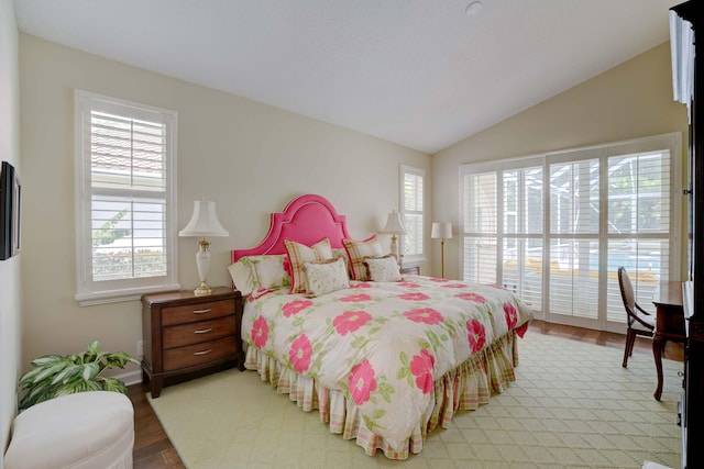 bedroom featuring hardwood / wood-style floors and vaulted ceiling