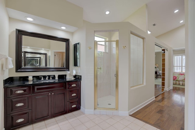 bathroom featuring tile patterned floors, vanity, a healthy amount of sunlight, and walk in shower