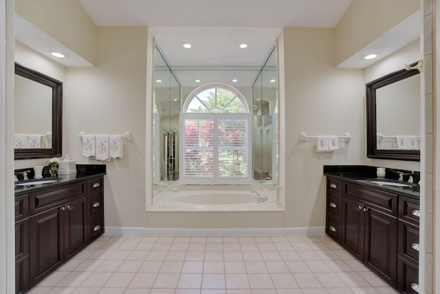 bathroom with vanity and a bath