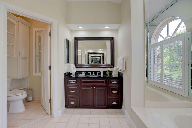 bathroom with tile patterned flooring, vanity, and toilet