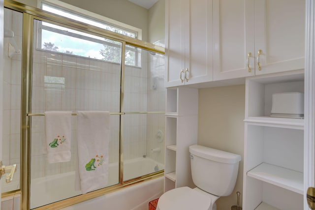 bathroom featuring toilet and enclosed tub / shower combo