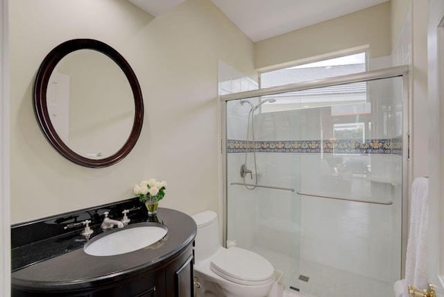 bathroom with vanity, toilet, and walk in shower