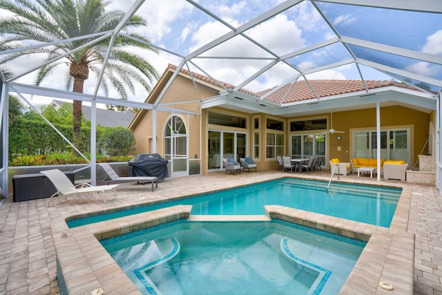 view of swimming pool featuring a lanai, outdoor lounge area, ceiling fan, and a patio