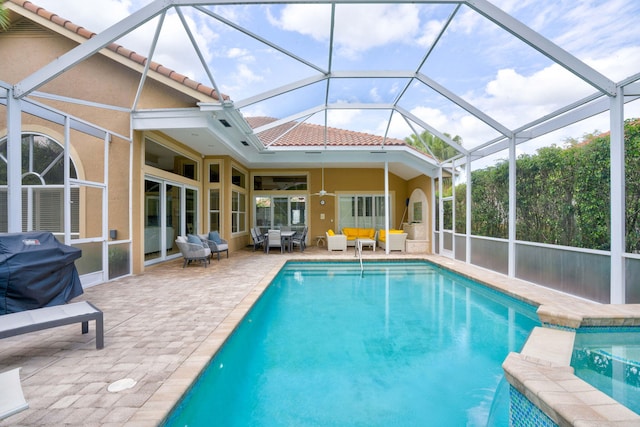 view of pool featuring a lanai, outdoor lounge area, a patio area, and a grill