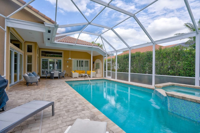 view of pool with an in ground hot tub, an outdoor living space, a patio, and a lanai