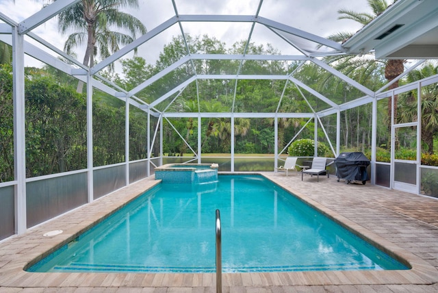 view of pool with glass enclosure, a grill, an in ground hot tub, and a patio