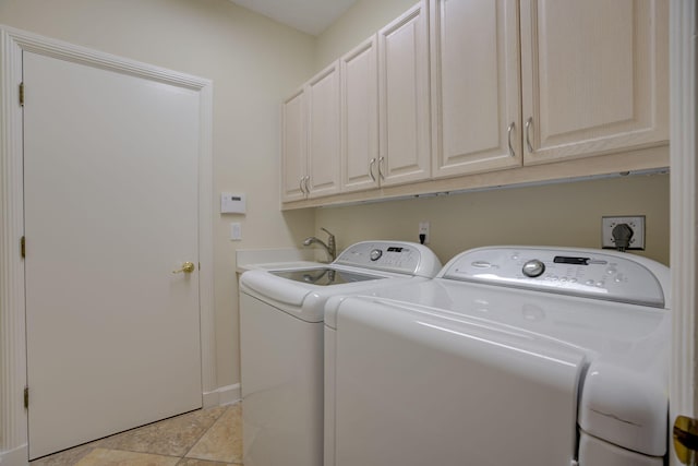 laundry area featuring sink, cabinets, and independent washer and dryer