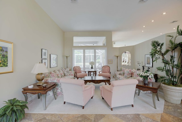 living room with a towering ceiling