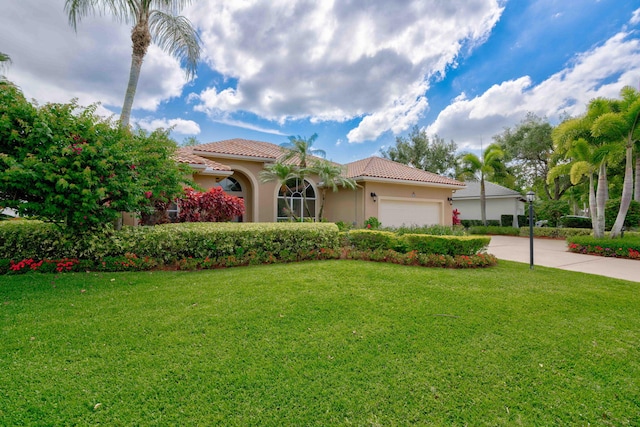 mediterranean / spanish-style home featuring a front yard and a garage