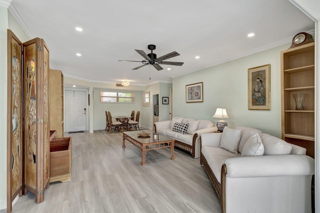 living room featuring light hardwood / wood-style flooring, ceiling fan, and ornamental molding