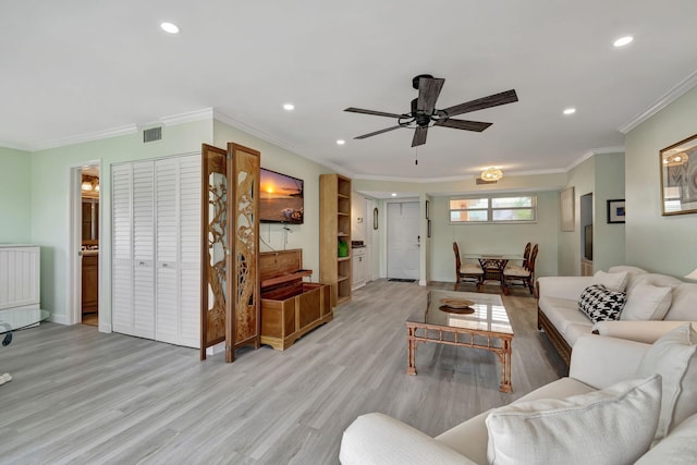 living room with ceiling fan, light hardwood / wood-style floors, and ornamental molding