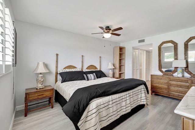 bedroom with ceiling fan and light wood-type flooring