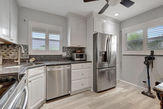 kitchen with white cabinets, a wealth of natural light, sink, and appliances with stainless steel finishes