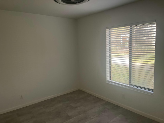 spare room featuring plenty of natural light and baseboards