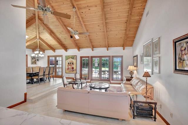 living room featuring french doors, ceiling fan with notable chandelier, light tile patterned floors, wooden ceiling, and beamed ceiling