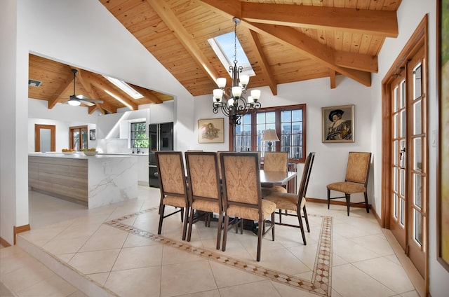 tiled dining area featuring french doors, ceiling fan with notable chandelier, vaulted ceiling with skylight, and wood ceiling