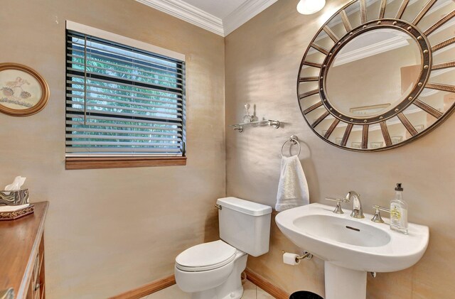 bathroom featuring sink, toilet, and crown molding