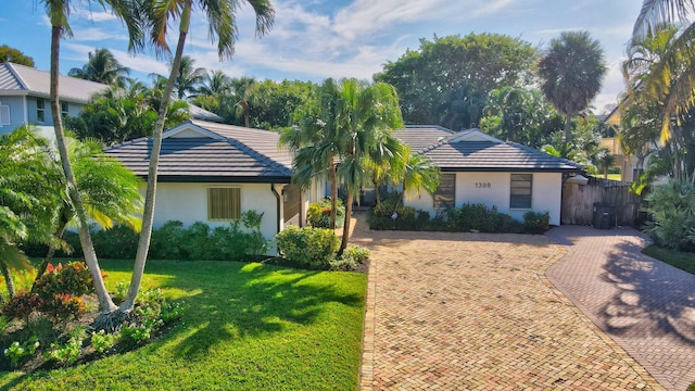 ranch-style home with a front yard