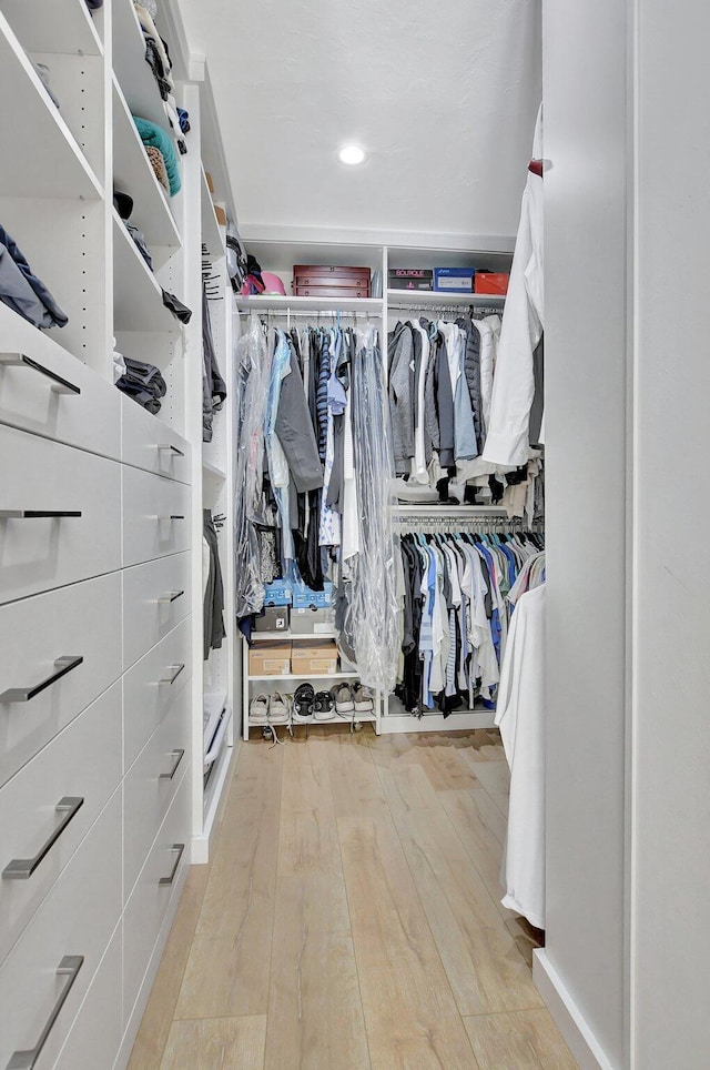 walk in closet featuring light hardwood / wood-style floors