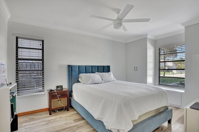 bedroom with ceiling fan, light wood-type flooring, and crown molding