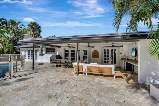 back of house with outdoor lounge area, french doors, ceiling fan, and a patio area