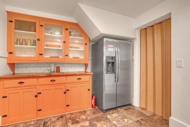 kitchen featuring decorative backsplash and stainless steel fridge with ice dispenser