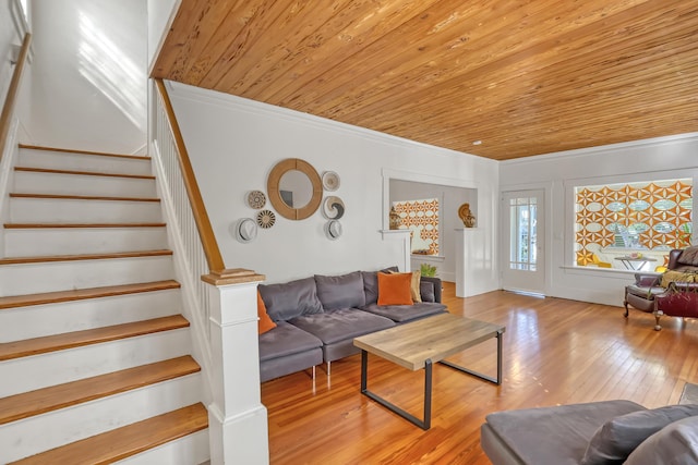 living room featuring wooden ceiling, light hardwood / wood-style floors, and ornamental molding