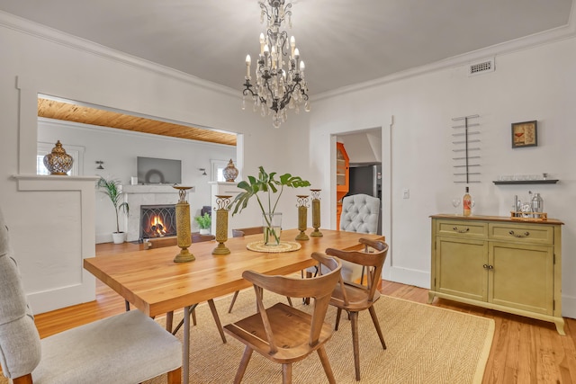 dining area featuring light hardwood / wood-style flooring and ornamental molding