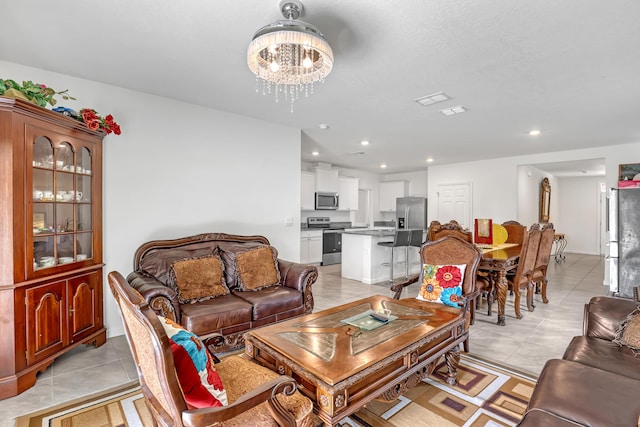 living room with light tile patterned flooring and a chandelier