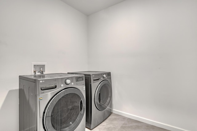 clothes washing area with independent washer and dryer