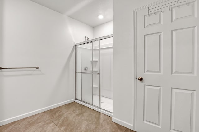 bathroom with tile patterned floors and walk in shower