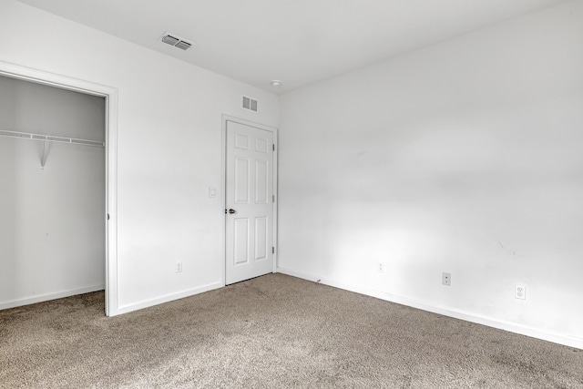 unfurnished bedroom with a closet and carpet