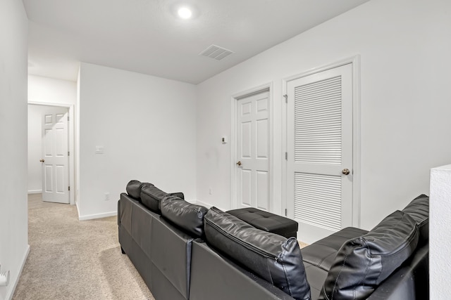 home theater room featuring light colored carpet