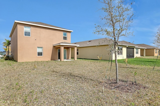 rear view of house with a yard