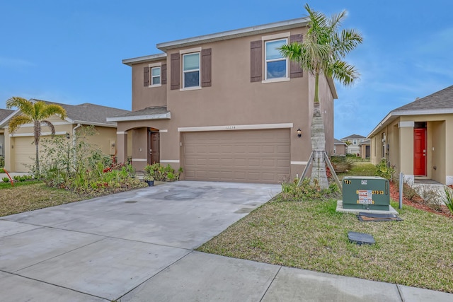 view of front of property featuring a garage and a front yard