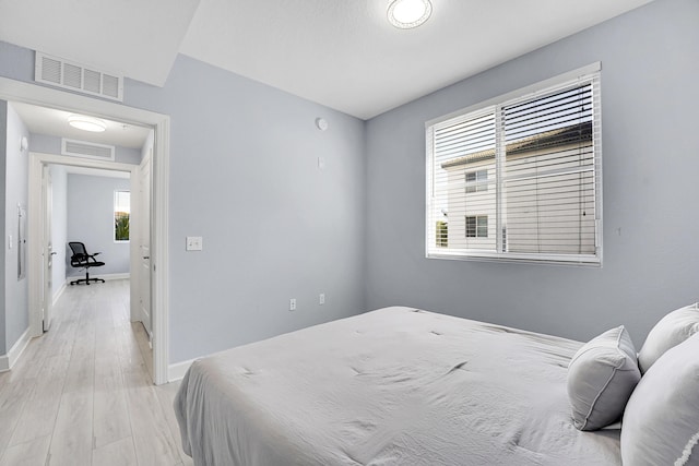 bedroom with light wood-type flooring