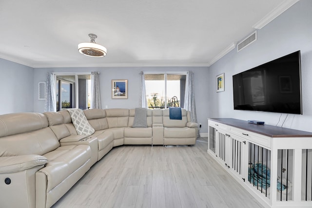 living room featuring light hardwood / wood-style floors and crown molding