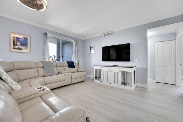 living room with crown molding and light hardwood / wood-style floors