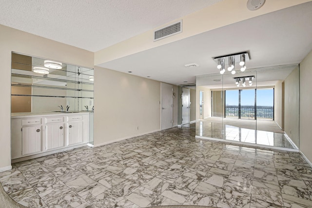 interior space with sink and a textured ceiling